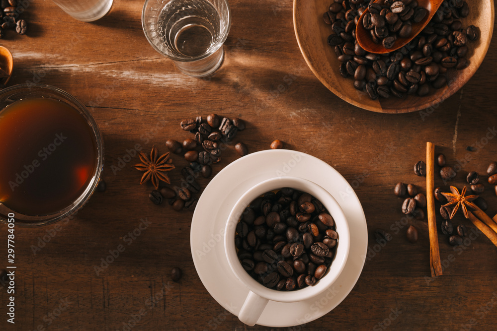 Black coffee in a cup on the background of coffee beans in a composition with accessories Black coffee in a cup on the background of coffee beans in a composition with accessories
