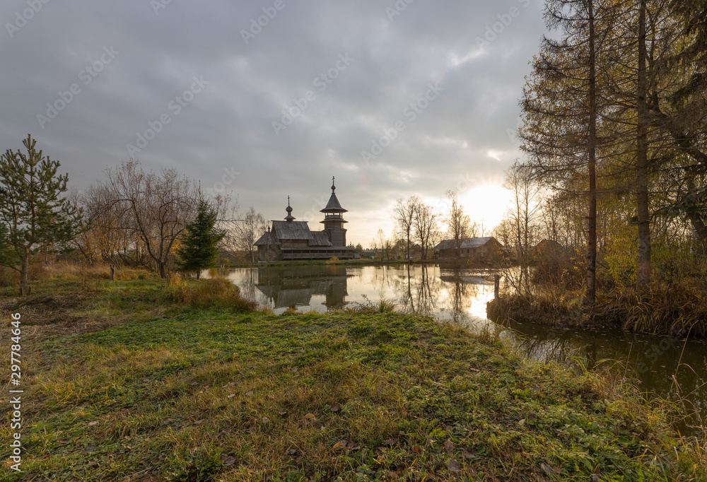 Wooden orthodox church of the Annunciation and its reflection in the lake on an autumn day. Moscow region, Sergiev Posad district. The Blagoveshheniye village