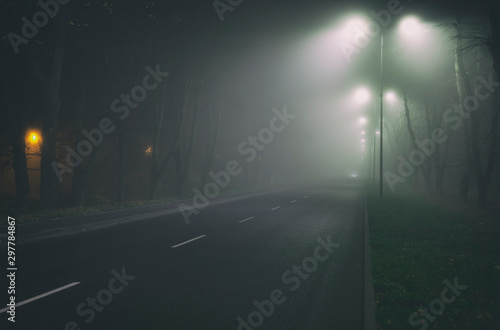 The thick fog above the asphalt road in the night in the city © SkyLine