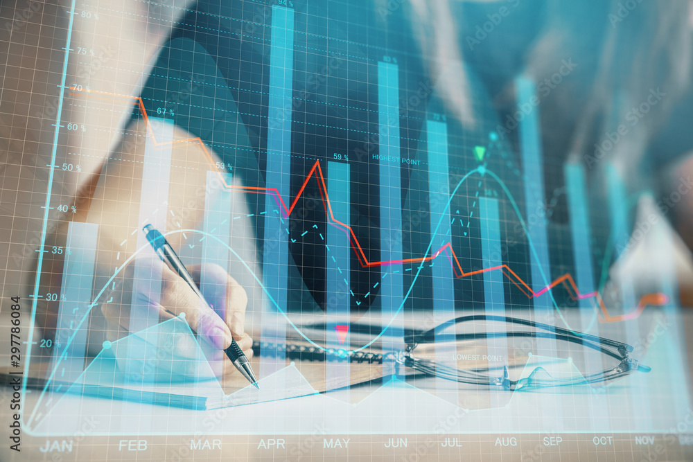 Multi exposure of woman's hands making notes with forex graph hologram. Concept of technical analysis. Multi exposure of woman's hands making notes with forex graph hologram. Concept of technical analysis.