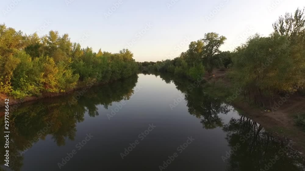 Aerial drone shot flying over the autumn forest valley and river, aerial vew Aerial drone shot flying over the autumn forest valley and river, aerial vew