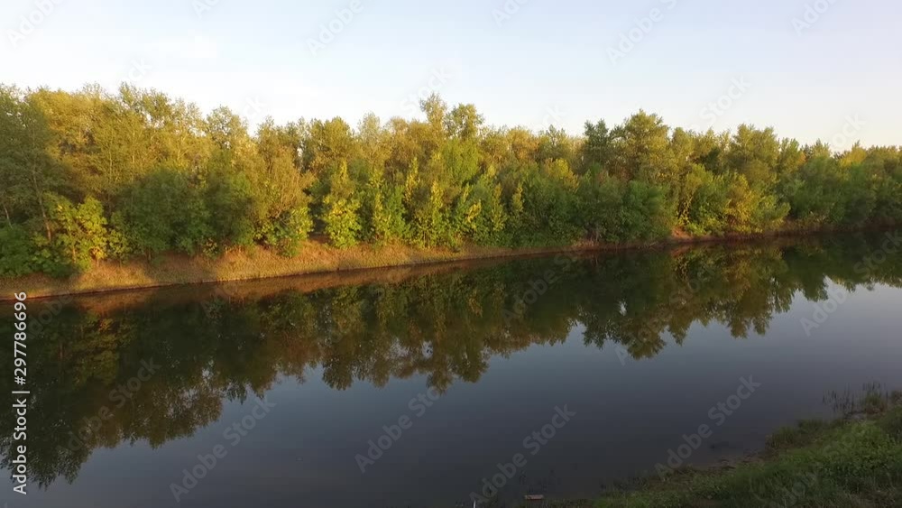 Aerial drone shot flying over the autumn forest valley and river, aerial vew Aerial drone shot flying over the autumn forest valley and river, aerial vew