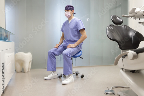 Meditating dentist in correct sitting position  on chair in his office. photo