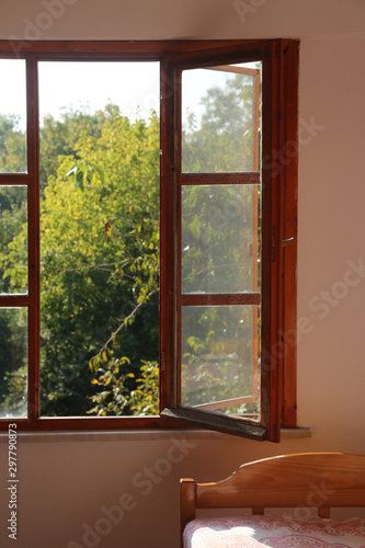 Light entering the bedroom through the wooden window 