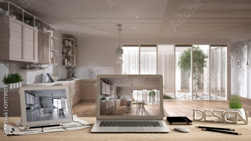 Architect designer desktop concept  laptop and tablet on wooden desk with screen showing interior design project and CAD sketch  blurred draft in the background  modern white kitchen