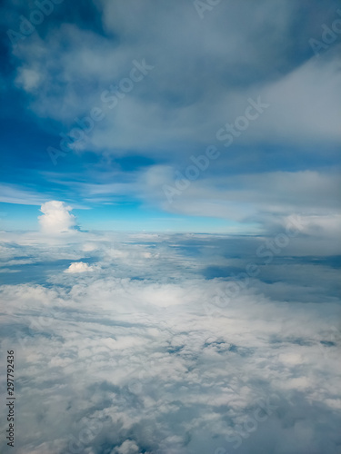 Sunrise above clouds from airplane window. Bright blue sky top horizontal view copyspace. Travelling concept View of the engine. © Elina