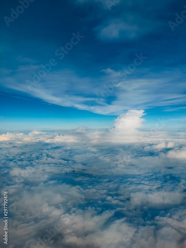 Sunrise above clouds from airplane window. Bright blue sky top horizontal view copyspace. Travelling concept View of the engine. © Elina