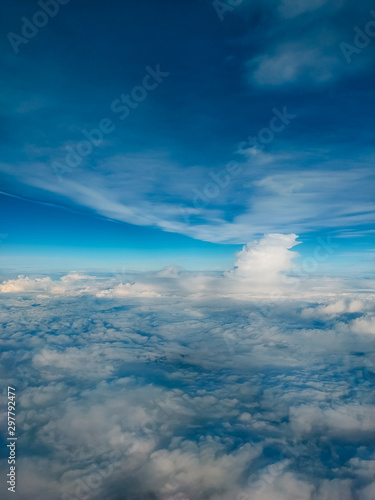 Sunrise above clouds from airplane window. Bright blue sky top horizontal view copyspace. Travelling concept View of the engine.