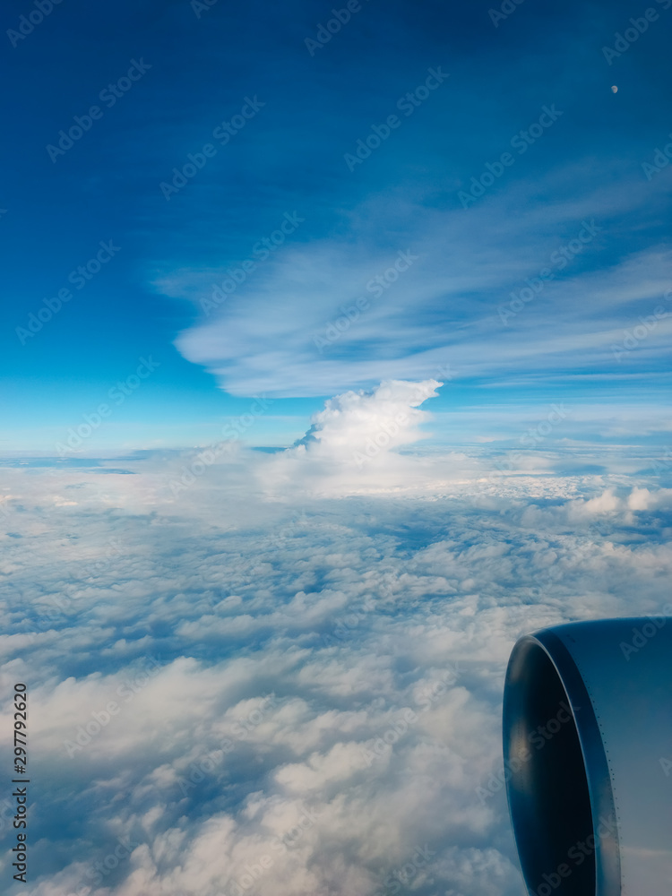 Sunrise above clouds from airplane window. Bright blue sky top horizontal view copyspace. Travelling concept View of the engine. Sunrise above clouds from airplane window. Bright blue sky top horizontal view copyspace. Travelling concept View of the engine.