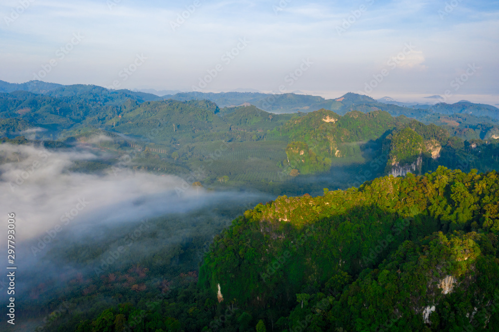 Aerial view of mountains with cloud cover mountain at sunrise and blue sky in Surat Thani Province, Thailand. Aerial view of mountains with cloud cover mountain at sunrise and blue sky in Surat Thani Province, Thailand.