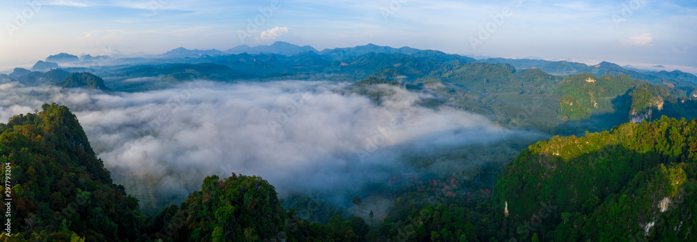 Aerial view of mountains with cloud cover mountain at sunrise and blue sky in Surat Thani Province, Thailand. Aerial view of mountains with cloud cover mountain at sunrise and blue sky in Surat Thani Province, Thailand.