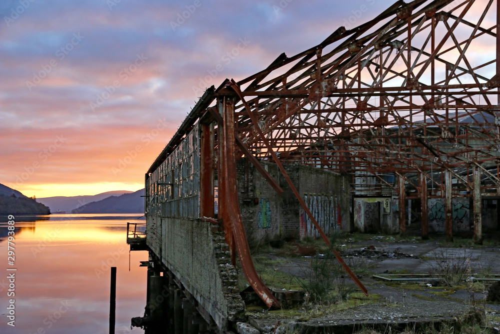 Derelict warehouse at Sunset over Loch Long, Scotland Derelict warehouse at Sunset over Loch Long, Scotland