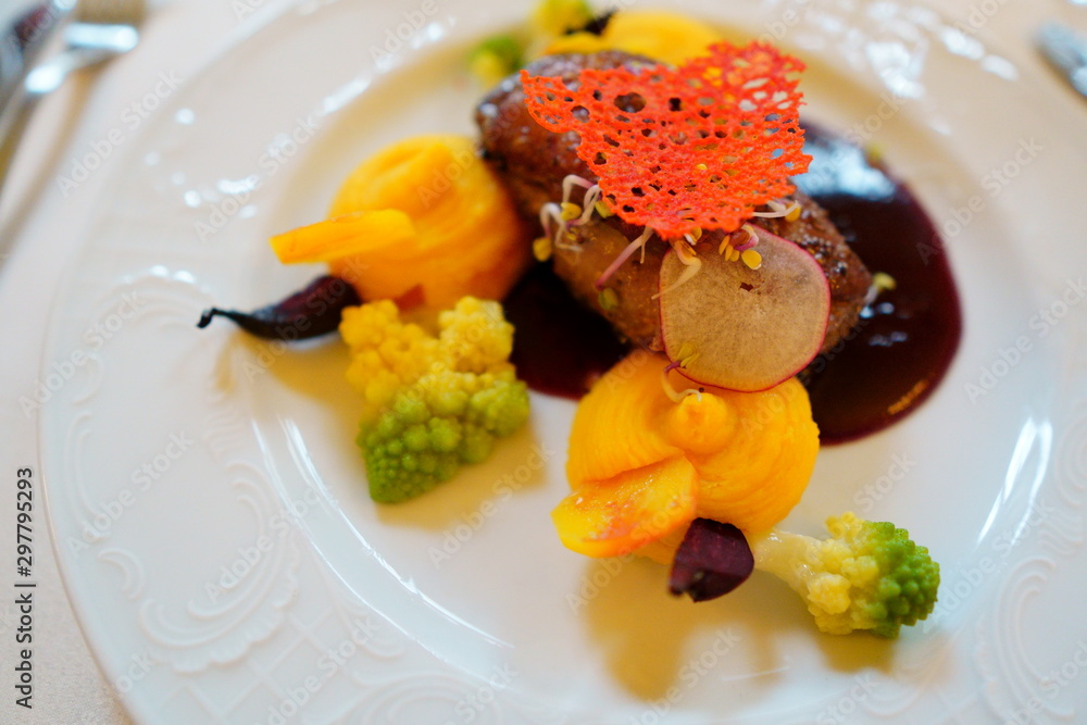 main course in the restaurant. The food is nicely laid on a white plate with a delicate pattern. mouth-watering dish and beautiful play of colors main course in the restaurant. The food is nicely laid on a white plate with a delicate pattern. mouth-watering dish and beautiful play of colors