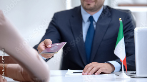 Fotografia Italian consular officer giving passport to immigrant, citizenship for refugee