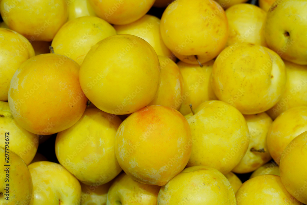 Background of yellow ripe plums. Close up photo Background of yellow ripe plums. Close up photo