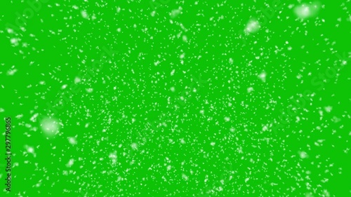 Isolated realistic snow falling on a green screen background