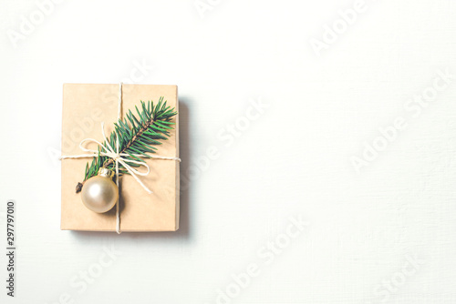 Christmas gift with fir branch on white background. Flat lay, top view. Copy space foryour text.