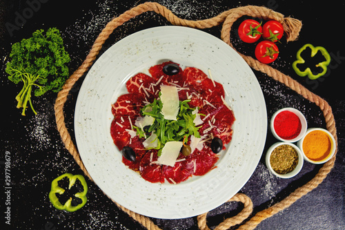 beef carpaccio with parmesan, arugula and olives