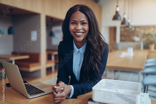 Smiling young African American businesswoman working in an offic photo