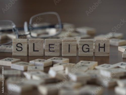 The concept of sleigh represented by wooden letter tiles photo
