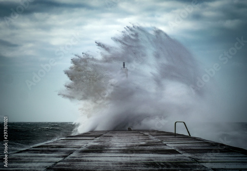 Strong winds create big waves that batter into Aberystwyth, Mid Wales sea front during the Storm season.