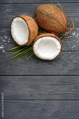 three brown coconut on old wooden board