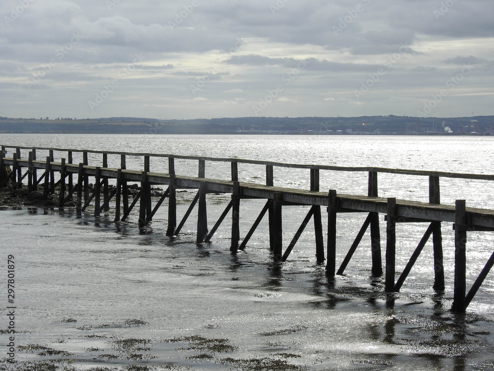 Long wooden pier on an overcast day in Scotland