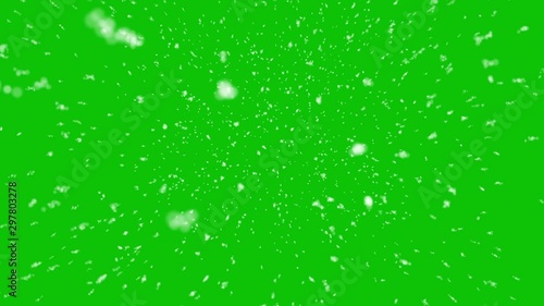 Isolated realistic snow falling on a camera.  Green screen background