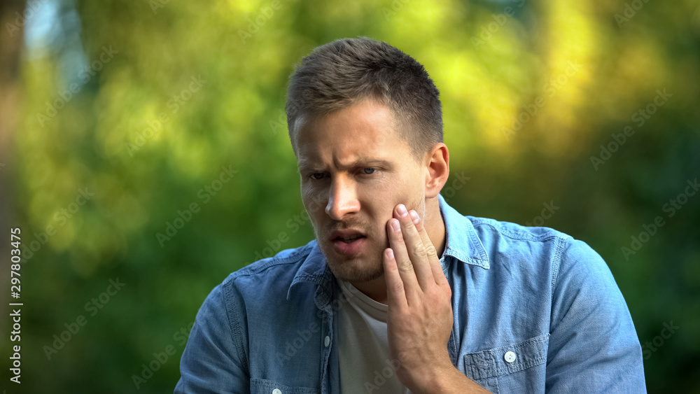 Man feeling dental pain, sensitive teeth, inflammation symptom, health care Man feeling dental pain, sensitive teeth, inflammation symptom, health care