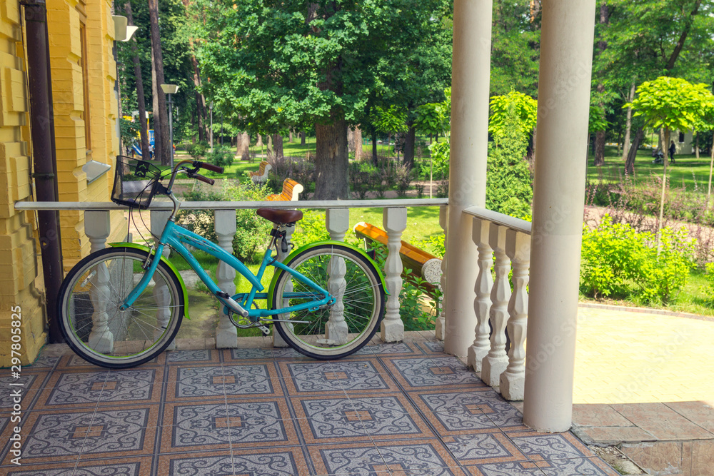 Fototapeta premium Bicycle stands on the porch of the house.