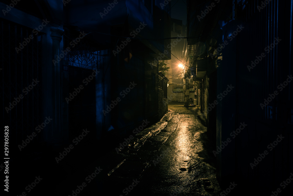 Empty and dangerous looking urban back-alley at night time in suburbs Hanoi