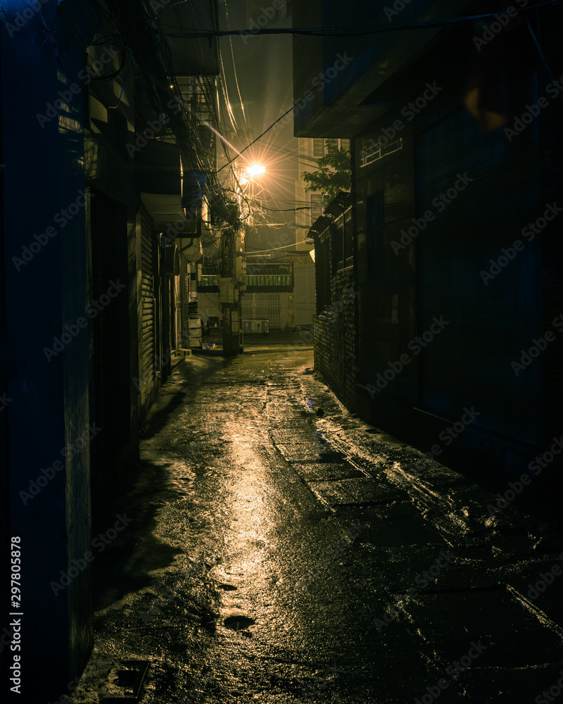 Filtered image empty and dangerous looking urban back-alley at night time in suburbs Hanoi - obrazy, fototapety, plakaty 