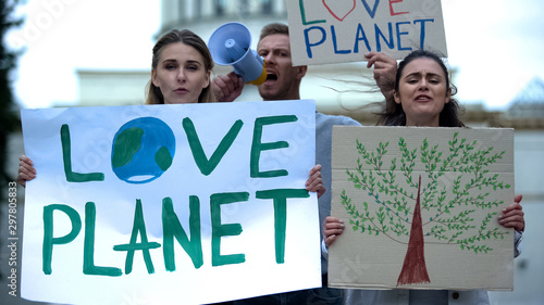 Young people chanting slogans about planet ecology, deforestation problems © motortion