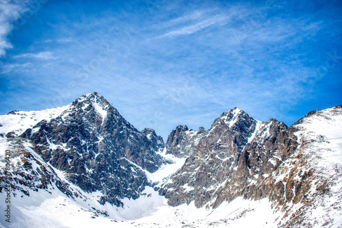 Snowy Lomnicky peak on a sunny day with a blue sky