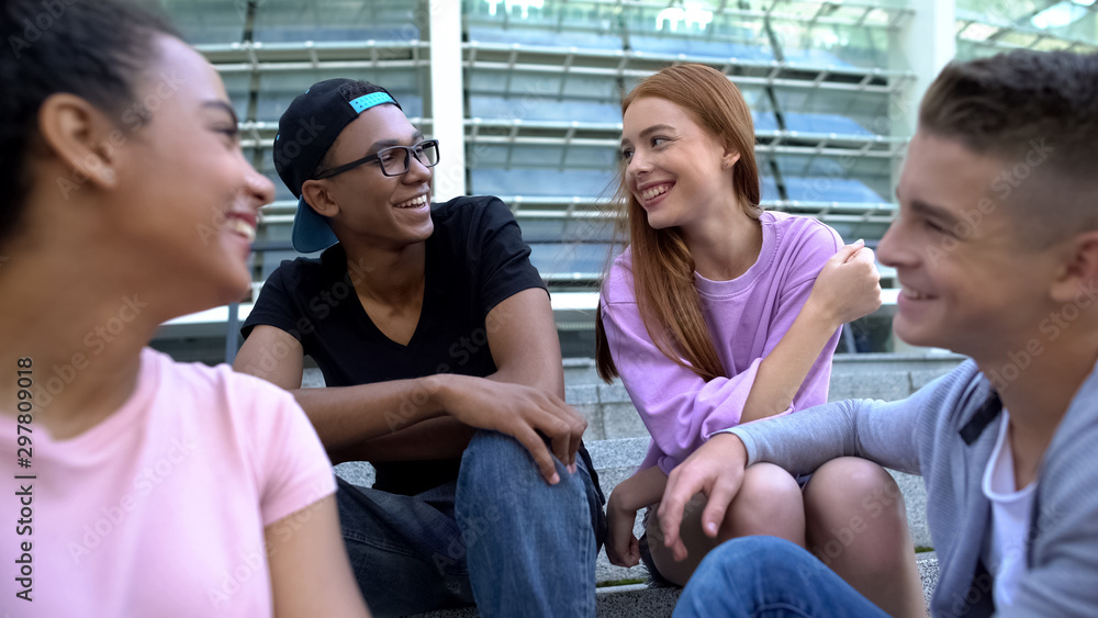 Obraz premium Male and female millennials smiling each other sitting aside, romantic relations