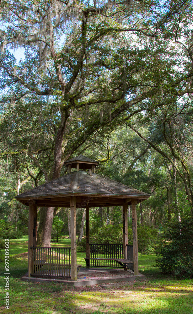 A peaceful park setting with an old gazebo.