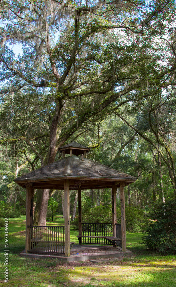 A peaceful park setting with an old gazebo. A peaceful park setting with an old gazebo.