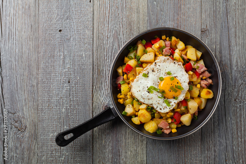 Traditional American hash with fried eggs. Top view.