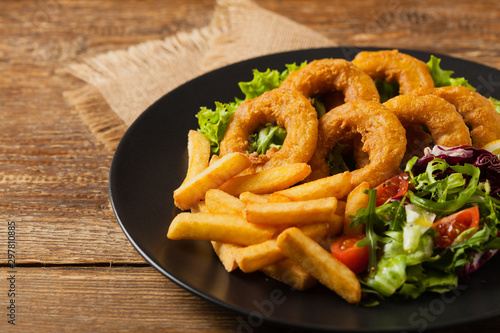 Roasted squid rings with fries.
