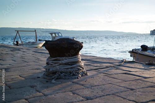 Stone port and scenic blue sea. Fisherman rope.