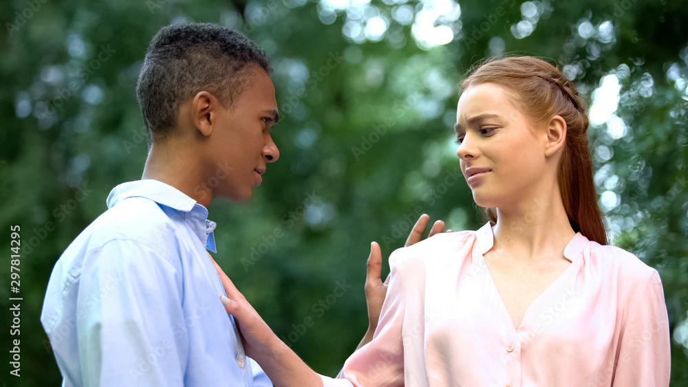 Confident teenage girl stopping boyfriend trying to kiss her, unrequited love Confident teenage girl stopping boyfriend trying to kiss her, unrequited love