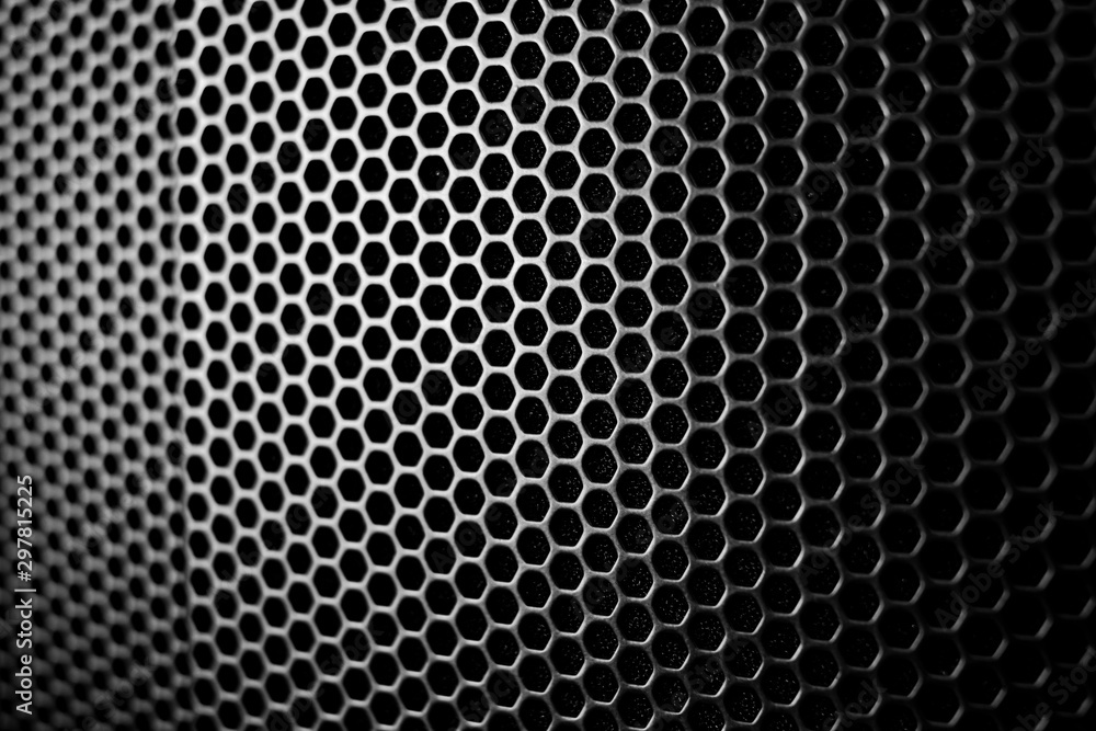 Satin and black metal grid macro protecting an amplifier as a wallpaper Satin and black metal grid macro protecting an amplifier as a wallpaper