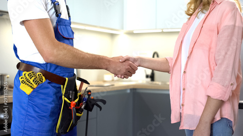 Fotografía Plumber with tools shaking client hand, technical maintenance, repair services