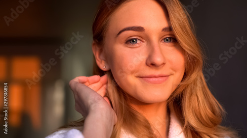 Attractive woman smiling into camera, young healthy skin, natural beauty closeup