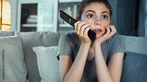 Young girl watching tv at home photo