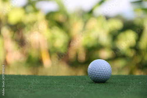 Golf ball on green grass in beautiful golf course