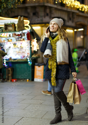 Girl talking on smartphone at Christmas market