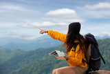 Asian woman Tourism traveler hikers with a backpack looking on map