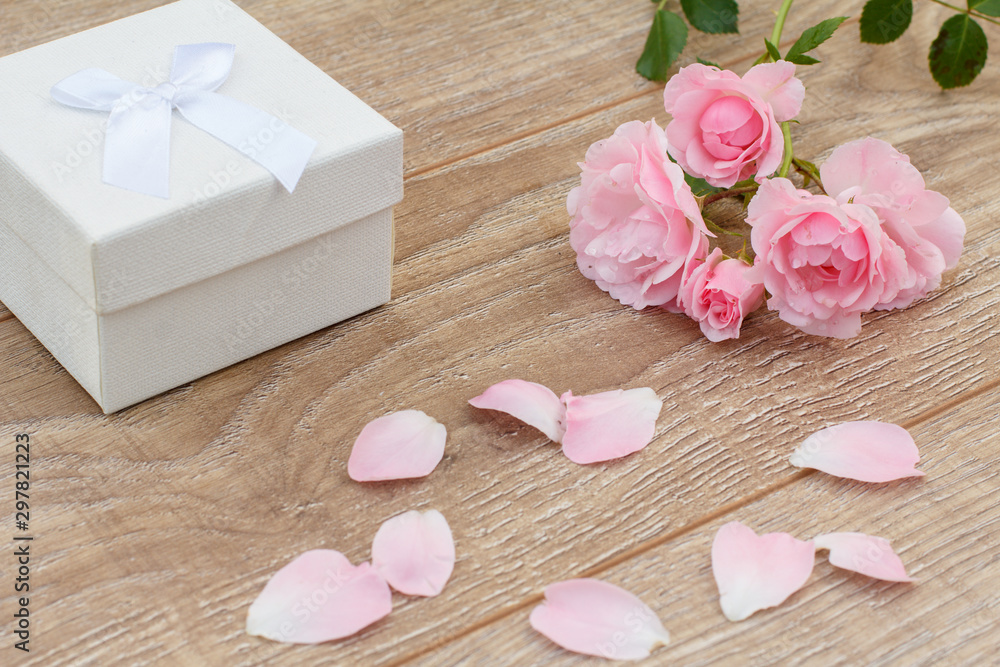 Gift box with rose flowers on the wooden background. Gift box with rose flowers on the wooden background.