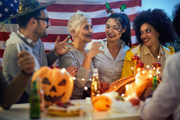  people in costume celebrate together a halloween party